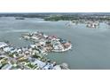 Stunning aerial view of waterfront homes with boat docks and access to the bay, surrounded by calm water at 16103 6Th E St, Redington Beach, FL 33708