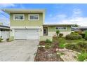 Charming two-story home with attached garage and well-maintained landscaping at 16103 6Th E St, Redington Beach, FL 33708