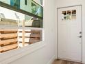 Bright entryway with a charming front door featuring glass panes and lots of natural light at 1622 Wisconsin Ln, Sarasota, FL 34239