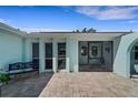 Inviting front entry featuring tiled flooring, bench seating, and a decorative door with a screen at 1714 Coral Sands Ct, Venice, FL 34293