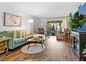 Bright living room featuring hardwood floors, comfortable couch, and access to an outdoor patio at 2526 Clubhouse Dr # 203, Sarasota, FL 34232