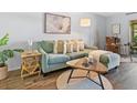 Inviting living room features a comfortable couch, wood floors, and stylish décor at 2526 Clubhouse Dr # 203, Sarasota, FL 34232