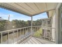 Relaxing screened balcony overlooks tranquil water views and lush tropical landscaping at 2851 Swifton Dr # 39, Sarasota, FL 34231