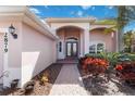 Inviting front entrance with double doors, lush landscaping, and brick pathway at 2879 Grazeland Dr, Sarasota, FL 34240