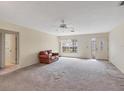 Bright living room with neutral carpet and ceiling fan at 4223 Oakhurst E Cir # 3025, Sarasota, FL 34233