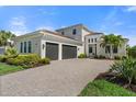 Beautiful exterior of a well-maintained home boasting a three-car garage and a lush, landscaped yard at 4790 Pastel Ct, Sarasota, FL 34240