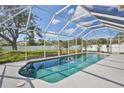 Sparkling pool is surrounded by a screened enclosure offering pristine views of the backyard at 4920 Breakwater Dr, Bradenton, FL 34203