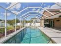 Private screened-in pool offers refreshing retreat with views of lush backyard landscaping at 4920 Breakwater Dr, Bradenton, FL 34203