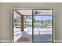 Screened lanai door offers picturesque view of the pool and fenced backyard at 4920 Breakwater Dr, Bradenton, FL 34203