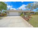 Well-maintained single-story home with a two-car garage, landscaped front yard, and concrete driveway at 5322 Ruby Ln, Sarasota, FL 34231