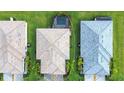 An aerial view of multiple residences showing roof tops and backyard pools at 5433 Mystic Water Cv, Lakewood Ranch, FL 34211