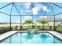 Screened pool with a brick deck and water feature overlooks beautifully landscaped back yard at 5433 Mystic Water Cv, Lakewood Ranch, FL 34211