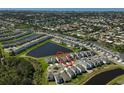 Aerial view of a residential neighborhood featuring single Gathering homes, ponds, and green spaces at 5675 Equator Ct, Nokomis, FL 34275
