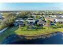 Aerial view of backyard with pool, screened-in lanai and waterfront views at 5709 Sunflower Cir, Sarasota, FL 34238