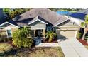 Attractive one-story home boasts verdant landscaping, palm trees and a 2 car garage at 5746 Hydrangea Cir, Sarasota, FL 34238
