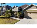 Well maintained single Gathering home with 2 car garage, manicured lawn and tropical landscaping at 5746 Hydrangea Cir, Sarasota, FL 34238