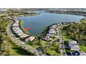 Aerial view of a lakeside community featuring multiple homes at 7717 Mainsail Ln, Sarasota, FL 34240
