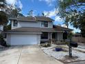 Charming two-story home featuring a well-maintained front yard and a welcoming entrance at 810 Hammockwood Ct, Sarasota, FL 34232