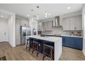 Modern kitchen featuring stainless steel appliances, a center island with seating, and stylish pendant lighting at 8330 Abalone Loop, Parrish, FL 34219