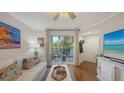 Bright living room with a white sofa, wood floors, and sliding doors to the patio at 850 S Tamiami Trl # 307, Sarasota, FL 34236
