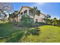 Lovely home showcasing balconies, lush landscaping, and a sprawling lawn at 9441 Discovery Ter # 101A, Bradenton, FL 34212