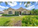 Inviting home with manicured lawn, mature landscaping, and large windows offering lots of natural light at 9612 Old Hyde Park Pl, Bradenton, FL 34202