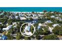 Beautiful aerial view showcases the home's proximity to the beach, canal, and surrounding neighborhood at 123 Hammock Rd, Anna Maria, FL 34216