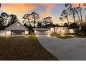 Charming home with a three-car garage and a separate garage or storage area, nestled among mature trees at 13608 11Th E Ter, Bradenton, FL 34212