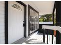 Inviting front porch with black and white trim and a charming front door at 1397 43Rd St, Sarasota, FL 34234