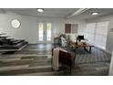 Open living room with gray flooring, a white sofa, and a stylish area rug at 1397 43Rd St, Sarasota, FL 34234