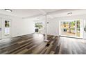 Bright living room featuring stylish flooring, multiple windows offering great natural light, and a large open space at 1397 43Rd St, Sarasota, FL 34234