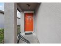 Eye-level view of the home's red front door at 16621 Sunburst Lake St, Wimauma, FL 33598