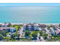 A captivating view of beachfront condo, showcasing lush landscaping, ample parking, and direct beach access at 1945 Gulf Of Mexico Dr # M2-110, Longboat Key, FL 34228