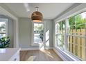 Sunlit living area with wood floors, large windows, and stylish wicker pendant light at 206 23Rd W St, Bradenton, FL 34205