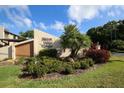 Charming Forest Lakes Village signage surrounded by lush greenery on a sunny day at 2446 Clubhouse Cir # 202, Sarasota, FL 34232