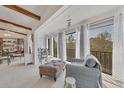 Bright living area with beamed ceilings, large windows to outdoor views and comfortable seating at 2446 Clubhouse Cir # 202, Sarasota, FL 34232