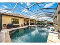 Stunning screened-in pool with ample seating, beautiful stone trim, and luxurious outdoor living at 26800 Pavin Dr, Englewood, FL 34223