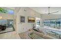 Bright living room features tall ceilings, a fireplace, and large windows offering views of the water at 3467 Byron Ln, Longboat Key, FL 34228