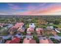 Aerial view of a residential neighborhood featuring pond views, mature trees, and well-maintained homes at 3715 80Th E Dr, Sarasota, FL 34243