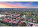 Community aerial view showcasing the neighborhood's layout, pond, and lush landscaping at 3715 80Th E Dr, Sarasota, FL 34243