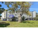Building exterior showcasing well-maintained landscaping, parking, and a view of the condo's balconies at 4240 Ironwood Cir # 302A, Bradenton, FL 34209