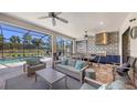 Inviting outdoor living space with a full kitchen, dining area, comfortable seating, and a view of the pool at 4717 Zeno Ct, Bradenton, FL 34211