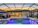 Beautiful outdoor pool and patio area featuring a covered lanai and lounge seating with a screened enclosure at 4717 Zeno Ct, Bradenton, FL 34211