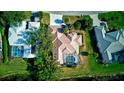 Aerial view of a well-maintained home with a screened-in pool and lush landscaping at 4724 White Tail Ln, Sarasota, FL 34238