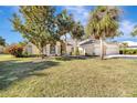Inviting home with a three-car garage, arched entryway, and well-manicured lawn at 4724 White Tail Ln, Sarasota, FL 34238