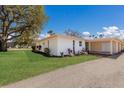 Well-maintained home with a large, green lawn, complemented by tasteful landscaping and a convenient covered carport at 5011 Live Oak Cir # 65, Bradenton, FL 34207