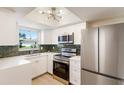 Updated kitchen features new stainless steel appliances, ample white cabinetry, and sleek countertops at 5011 Live Oak Cir # 65, Bradenton, FL 34207