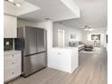 Modern kitchen with stainless steel appliances that opens up to a spacious living room and dining area at 5011 Live Oak Cir # 65, Bradenton, FL 34207