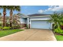 Charming single-story home featuring a spacious two-car garage and a beautiful, well-maintained lawn at 5068 Inshore Landing Dr, Apollo Beach, FL 33572