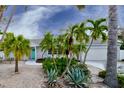 Cozy single-story home featuring tropical plants and a well-manicured landscape at 552 Juan Anasco Drive, Longboat Key, FL 34228